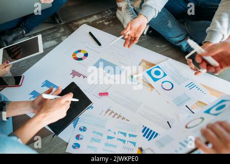startup diagrams analysis team floor brainstorming Stock Photo
