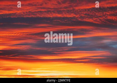 Abstract Saturated Orange-yellow Colors Of Clouds. Unusual Sky Background. Rich Orange Colors. Toned Pink-yellow Clouds. Sky Sunset Sunrise Background Stock Photo