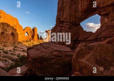 The back side of Double Arch and Cove Arch (front) in the Cove of Caves area of Arches National Park, Moab, Utah. Stock Photo