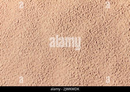 Horizontal shot of Abstract painted concrete orange wall background and texture with copy space. Top view texture smooth layer of orange sand with tra Stock Photo