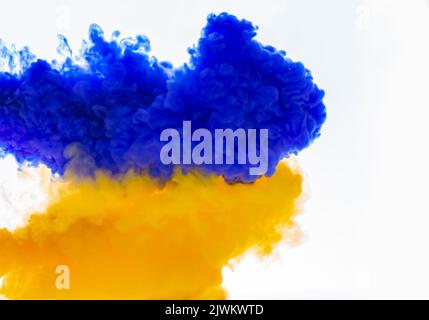 Splash of blue and yellow paint. Abstract background,selective focus.Texture of colored colorful clouds in transparent water. Senses and dream concept Stock Photo