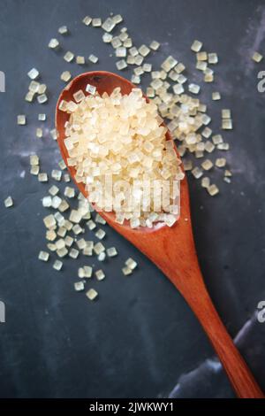 crystal brown sugar brown on a wooden spoon on table  Stock Photo
