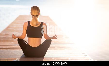 Life Harmony. Rear View Of Slim Female Meditating Outdoors Near The Sea Stock Photo
