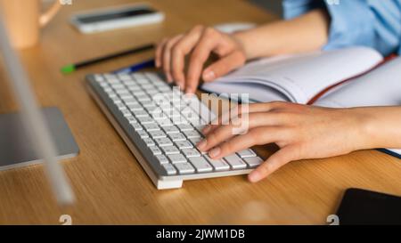 Closeup Of Female Hands On Computer Keyboard Typing At Workplace Stock Photo