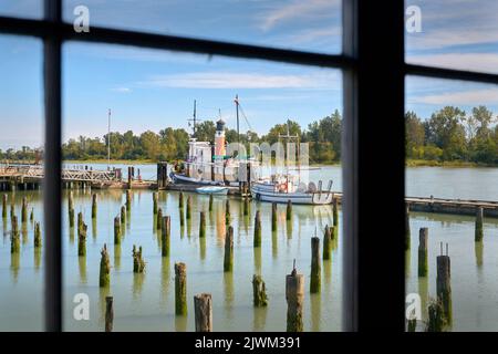 Britannia Shipyards through Heritage Window. Dock view through a window of the historic Britannia Heritage shipyard on the banks of the Fraser River i Stock Photo