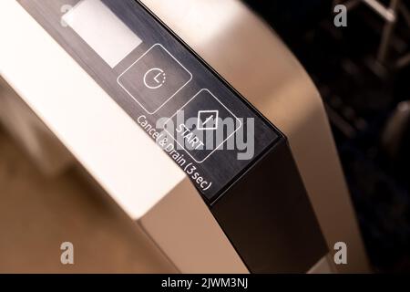Modern dishwasher start button on control panel closeup Stock Photo