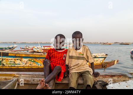 Dakar, Senegal - January 28, 2019: Two happy boys, standing outdoors at the coast Stock Photo