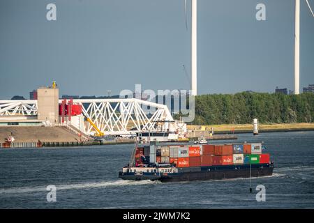 Shipping traffic on the Maas, height Hoek van Holland, inland cargo ship, container freighter, in front of the Maeslantkering storm surge barrier at t Stock Photo
