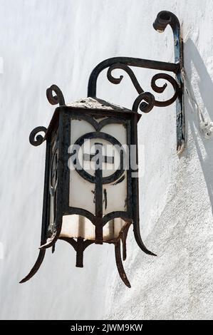 Vintage rusty street lantern on white wall Stock Photo