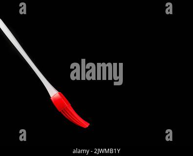 red and white  silicon pastry brush isolated on a black background Stock Photo