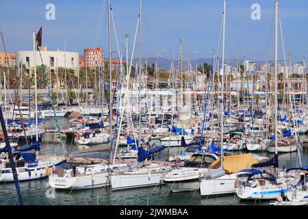 BARCELONA, SPAIN - OCTOBER 7, 2021: Yachts and sailboats in Marina Port Vell in Barcelona, Spain. Marina Port Vell is one of most recognizable harbors Stock Photo