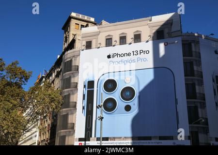 BARCELONA, SPAIN - OCTOBER 7, 2021: Huge billboard ad for Apple iPhone 13 Pro covering a whole building in downtown Barcelona city, Spain. Stock Photo
