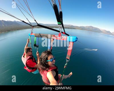 A woman enjoys parasailing in South Lake Tahoe, California. Stock Photo