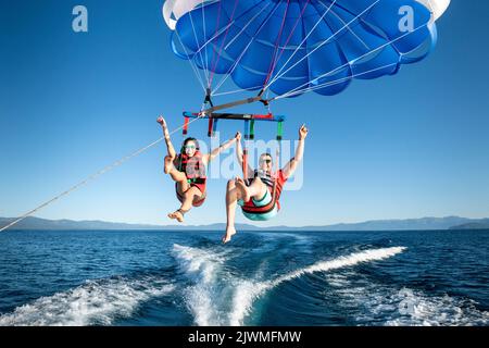 A man and a woman enjoy parasailing in South Lake Tahoe, California. Stock Photo