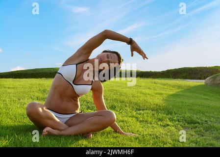 Mature sporty woman practicing stretching outdoor Stock Photo