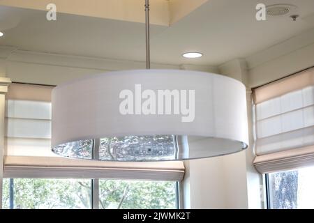 A white drum light fixture interior during the day Stock Photo