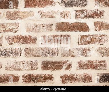 A light red brick and cream wall Stock Photo