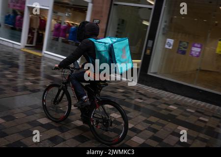 Fast food delivery couriers, for Deliveroo, and Just Eat, in Glasgow, Scotland, 6 September 2022. Stock Photo