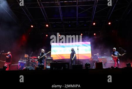 Vicenza, VI, Italy - September 4, 2022: Live Concert of an Italian band called NOMADI and Peace Flag on stage Stock Photo