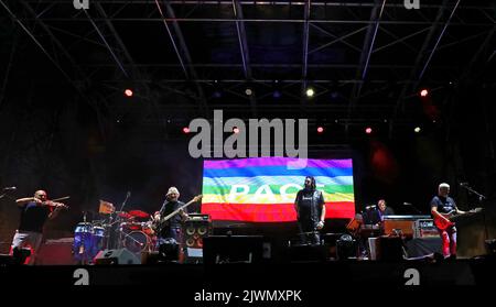 Vicenza, VI, Italy - September 4, 2022: Live Concert of an Italian band called NOMADI and Peace Flag on stage Stock Photo