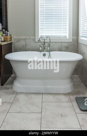 Master bathroom freestanding bathtub in a tiled master bathroom Stock Photo