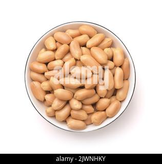 Top view of peeled roasted peanuts in ceramic bowl isolated on white Stock Photo