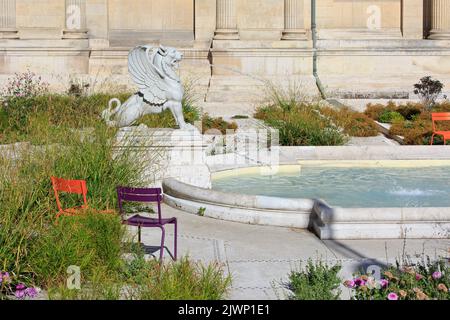 A statue of a griffin spouting water in a small pond in the gardens of the Picardy Museum (Musée de Picardie) in Amiens (Somme), France Stock Photo