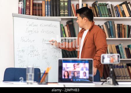 Japanese Male Tutor Having Online Lesson Making Video Call Indoor Stock Photo
