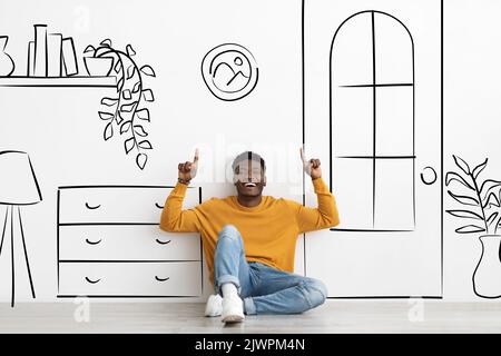 Joyful black man pointing up, showing dream home, collage Stock Photo