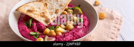 Close-up of Beetroot hummus on white table Stock Photo