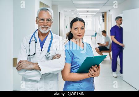 Portrait of happy medical team standing in hospital corridor after hard working day. medical teamwork Stock Photo