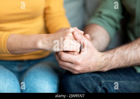Cropped Shot Of Loving Middle Aged Couple Holding Hands Together Stock Photo