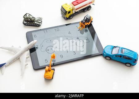 Tablet computer with different types of toy transport Stock Photo