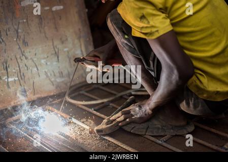 Man at work. A young welder observered at work in Lagos, NIGERIA, on September 1, 2022. Daily life in Lagos, Nigeria’s largest city, despite the rapid Stock Photo