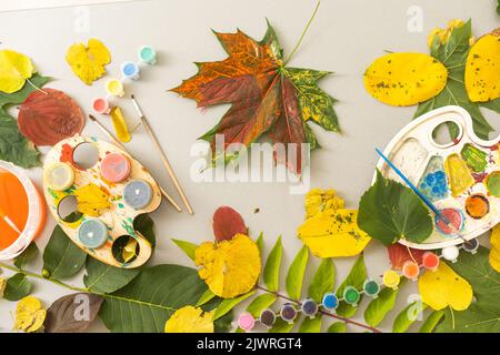 Children's picture made from autumn leaves with pencil drawing on paper Stock Photo