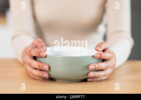Female hands holding empty plate, closeup photo Stock Photo