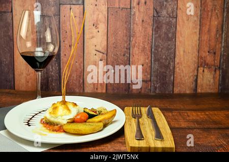 Cod loin with au gratin apple alioli sauce on tomato confit. Stock Photo