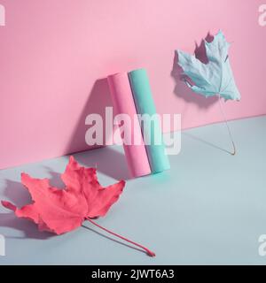 pink-blue chalk with autumn leaves paint on a blue-pink background Stock Photo