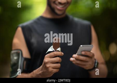 Cropped of sportsman having break while training in park Stock Photo