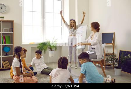 Funny preteen kids having fun and talking at group reception at school psychologist. Stock Photo
