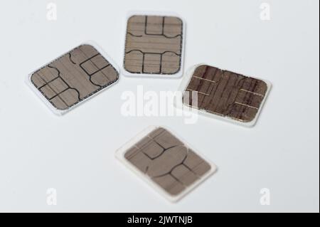 Mobile microchip simcards close up view isolated on studio background. Telecommunication theme Stock Photo