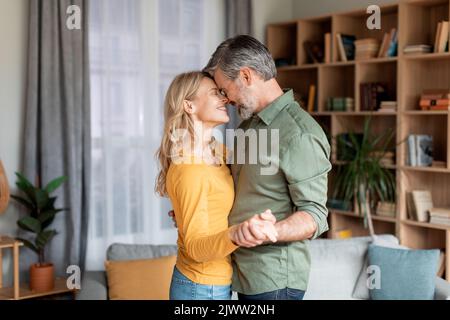 Domestic Romance. Loving Middle Aged Spouses Dancing Together At Home Stock Photo