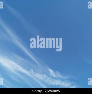 Full frame of pretty blue sky with pale white cloud formation Stock Photo