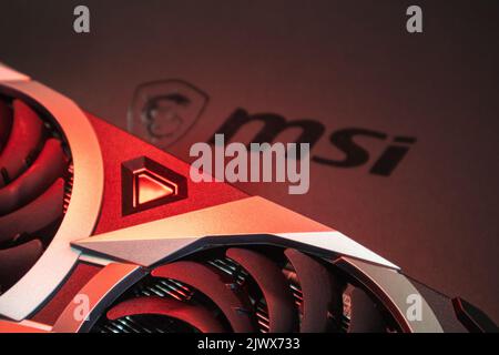 Kyiv, Ukraine - August 19, 2022: MSI graphics video card coolers in vibrant red light, close-up with selective focus Stock Photo