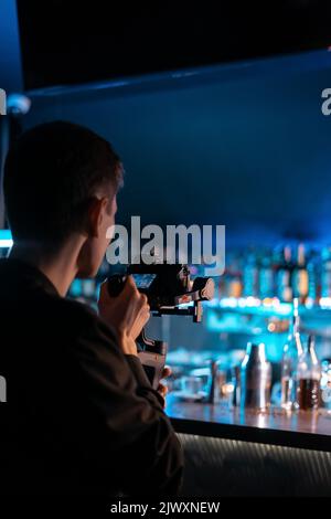 professional videographer operator shooting video with handheld gimbal, camera Stock Photo