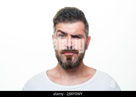 Serious man portrait. Beard and mustache. Looks seriously. Isolated. Hipster guy face expression. Closeup face. Stock Photo