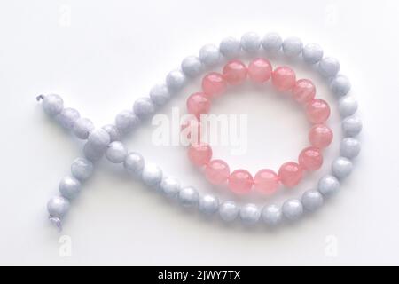 Rose quartz bracelet and aquamarine strand on the table. Stock Photo