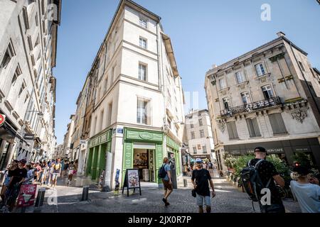 Old Town street full of people artists tourists art posters during the Avignon Festival Off. Avignon Festival is an annual arts festival held in Avign Stock Photo