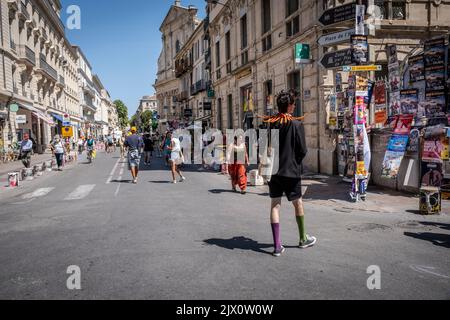 Old Town street full of people artists tourists art posters during the Avignon Festival Off. Avignon Festival is an annual arts festival held in Avign Stock Photo