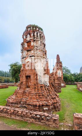 Dilapidated, crumbling red brick prangs in the ruins at Wat Maha That, the sacred royal temple in Ayutthaya, Thailand Stock Photo